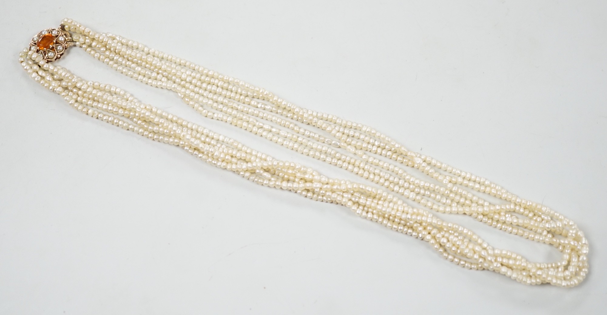 A 1960's Cropp & Farr multi strand seed pearl necklace, with 9ct gold, citrine and split pearl set clasp, 46cm.